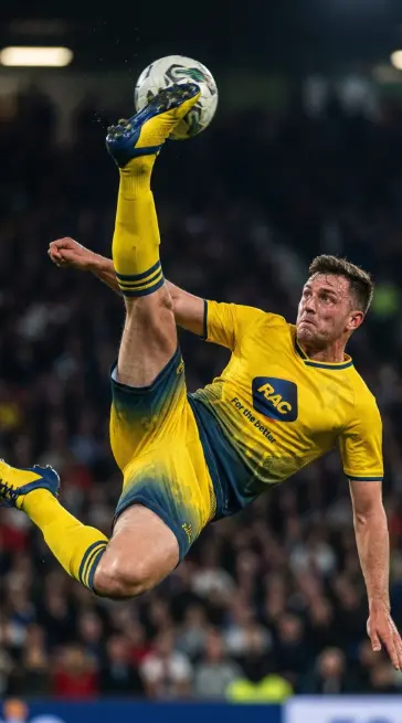 Soccer team celebrating with trophy in custom kits